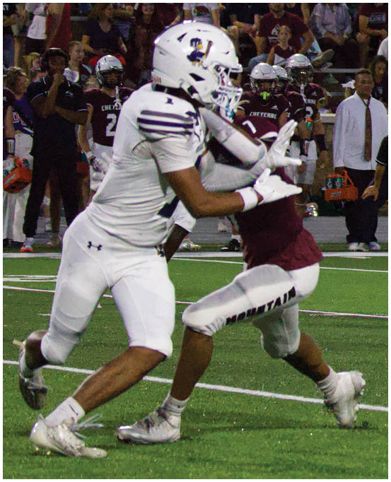 A group of football players wearing black and white uniforms. Description generated by AI