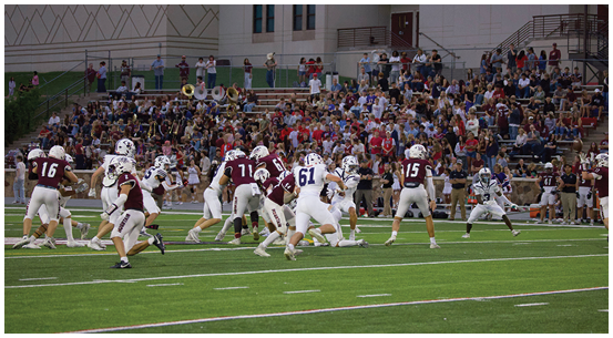 A group of football players on a field. Description generated by AI
