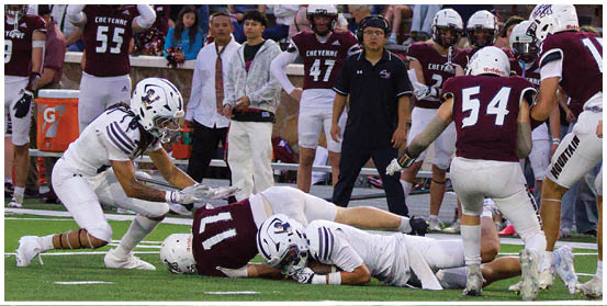 A football player is sliding on the ground. Description generated by AI