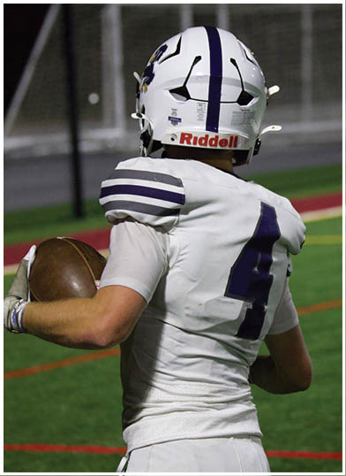 A football player wearing a blue jersey with the number 58 on it. Description generated by AI