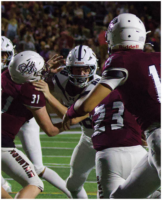 A group of football players wearing black and white uniforms. Description generated by AI