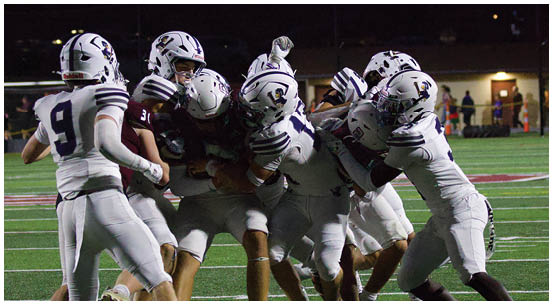 A group of football players on a field. Description generated by AI