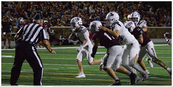 A football player is sliding on the ground. Description generated by AI