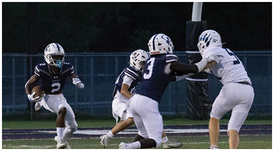 A group of football players on a field. Description generated by AI