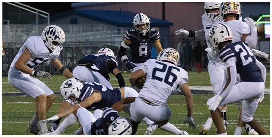 A football player is sliding on the ground. Description generated by AI