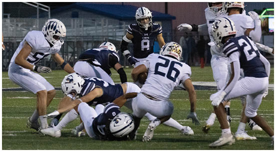 A group of football players on a field. Description generated by AI