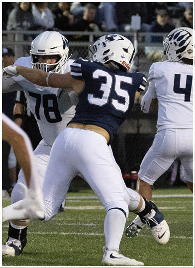 A football player wearing a blue jersey with the number 58 on it. Description generated by AI