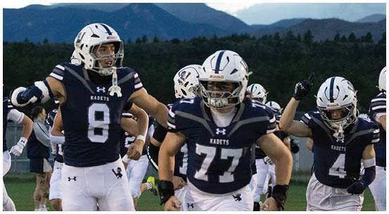 A group of football players on a field. Description generated by AI