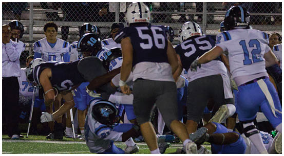 A group of football players on a field. Description generated by AI