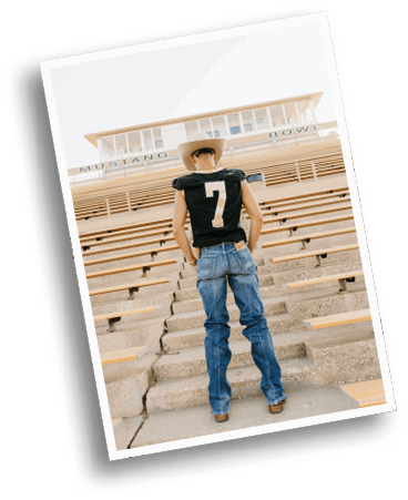 A person wearing a cowboy hat, a black sports jersey with the number seven, and jeans is standing on stadium steps facing empty bleachers under a sign that reads Mustang Bowl. Description generated by AI