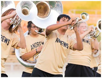 People wearing matching shirts with “ANDREWS" printed on them are playing brass instruments outdoors. Description generated by AI