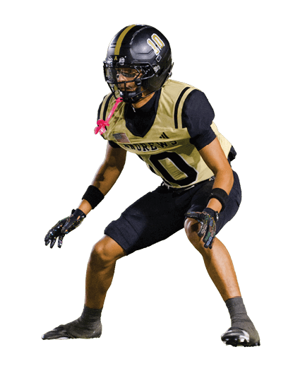 A person wearing a black and gold football uniform with the number 10 and a helmet is in a crouched, ready position. Description generated by AI