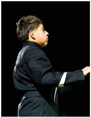 A person with short hair is partially visible at the bottom left corner against a black background. Description generated by AI