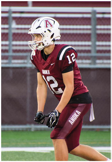 A football player wearing a blue and red jersey. Description generated by AI