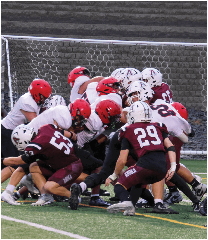 A group of football players on a field. Description generated by AI