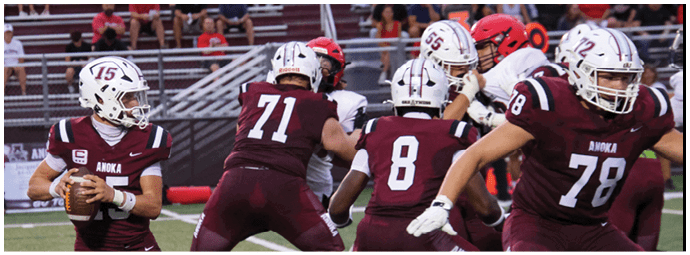 A group of football players on a field. Description generated by AI