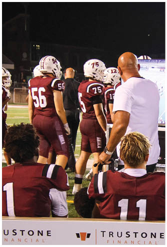 A group of football players celebrating a touchdown. Description generated by AI