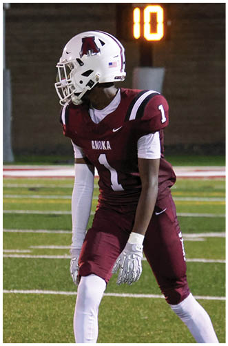 A football player wearing a blue and red jersey. Description generated by AI
