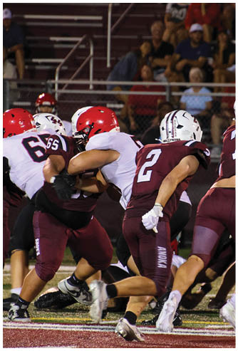 A group of football players celebrating a touchdown. Description generated by AI
