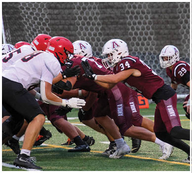 A football game is taking place with a group of men on the field. Description generated by AI