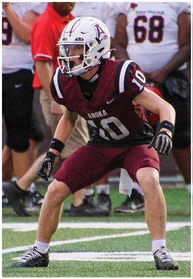 A football player wearing a blue and red jersey. Description generated by AI