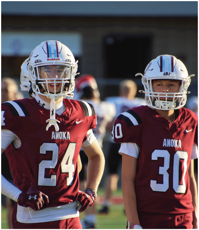A group of football players on a field. Description generated by AI