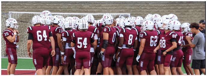 A group of football players on a field. Description generated by AI