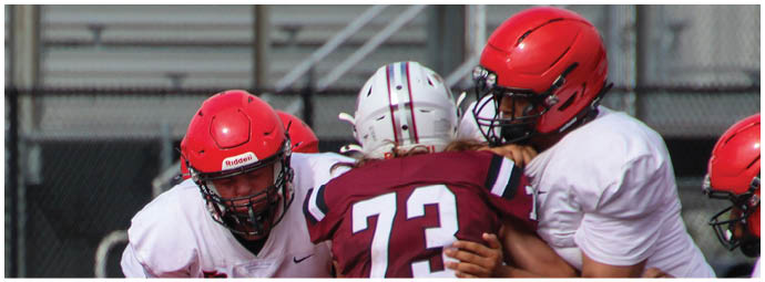 A football player wearing a blue and white uniform. Description generated by AI