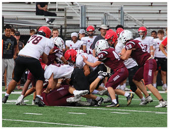 A group of football players on a field. Description generated by AI