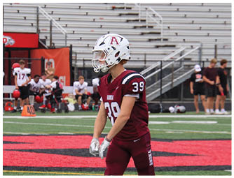 A group of football players on a field. Description generated by AI