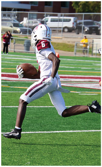 A football player catching a ball. Description generated by AI