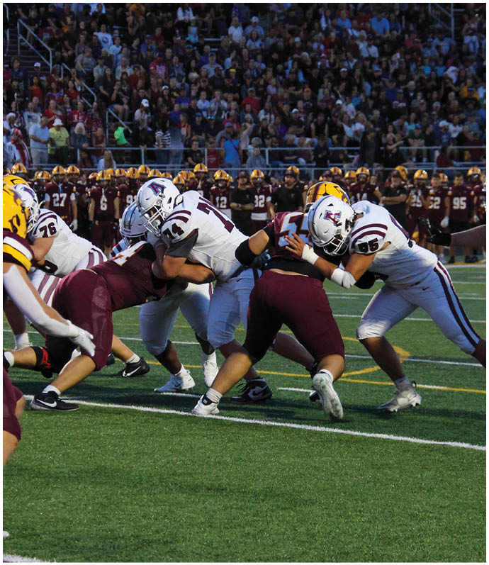 A group of football players on a field. Description generated by AI