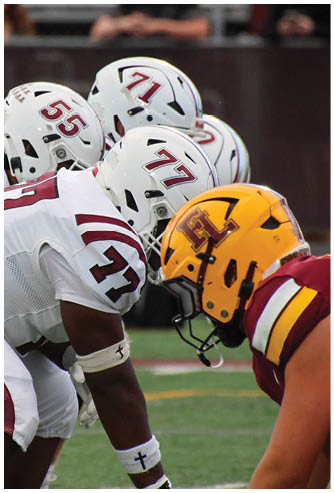 A group of football players celebrating a touchdown. Description generated by AI