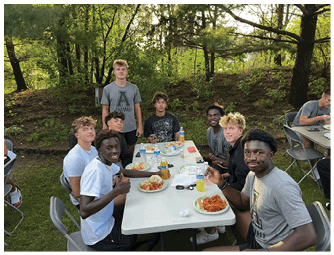 A group of football players on a field. Description generated by AI