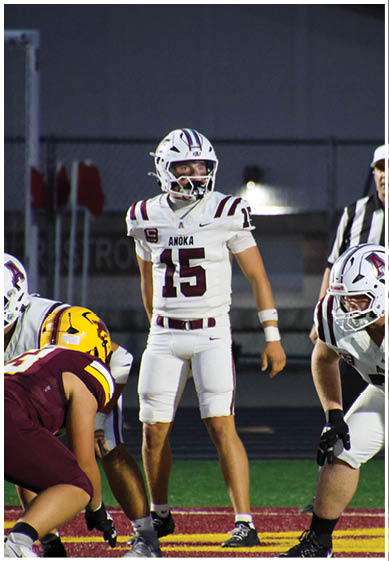 A football player wearing a blue and red jersey. Description generated by AI