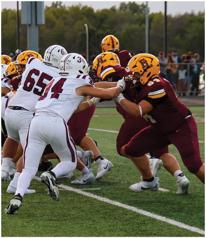 A group of football players on a field. Description generated by AI