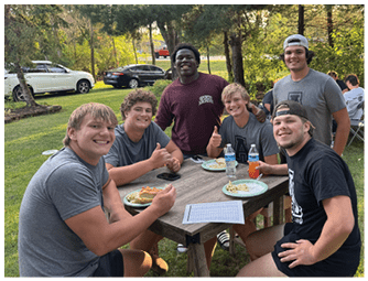 A group of football players on a field. Description generated by AI