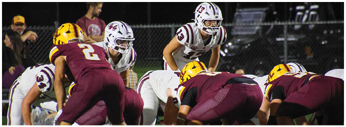 A group of football players on a field. Description generated by AI