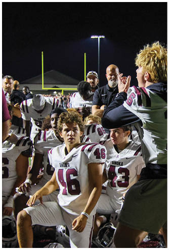 A group of football players celebrating a touchdown. Description generated by AI