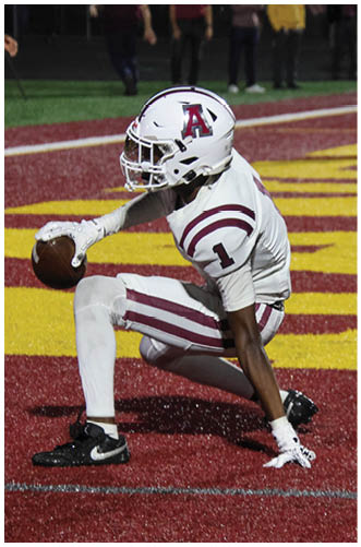 A football player wearing a blue and red jersey. Description generated by AI
