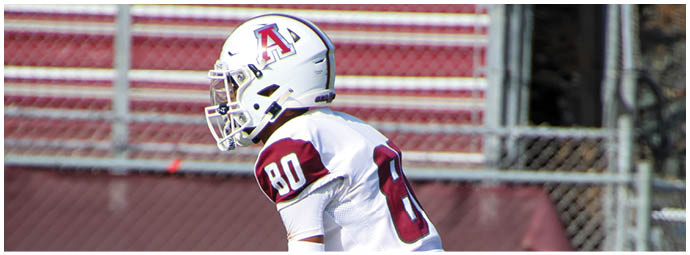 A football player wearing a blue and white uniform. Description generated by AI