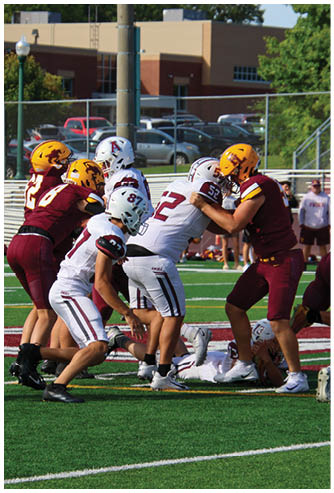 A football game is being played on a field. Description generated by AI