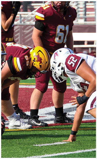 A football player catching a ball. Description generated by AI