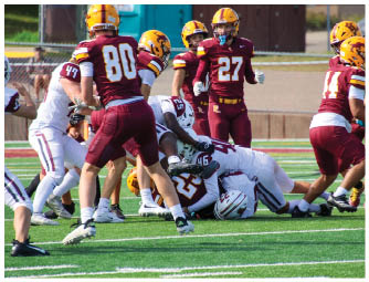 A group of football players on a field. Description generated by AI