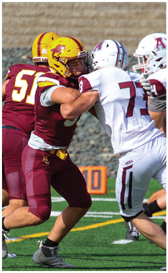A football player catching a ball. Description generated by AI