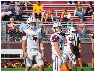 A group of football players on a field. Description generated by AI