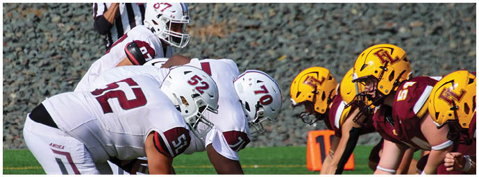 A football player wearing a blue and white uniform. Description generated by AI