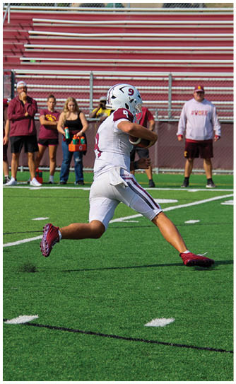 A football player catching a ball. Description generated by AI