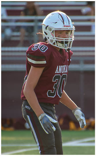 A football player catching a ball. Description generated by AI