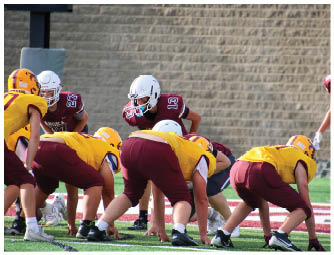 A group of football players on a field. Description generated by AI